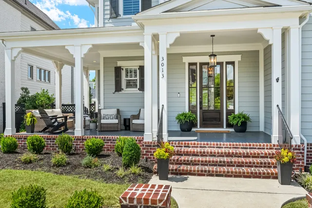 a living room with furniture a potted plant and a fireplace
