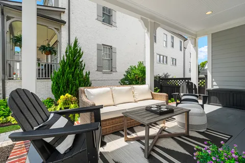a bed sitting in a spacious bedroom next to a window