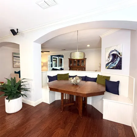 a kitchen with stainless steel appliances kitchen island granite countertop white cabinets a sink and a stove