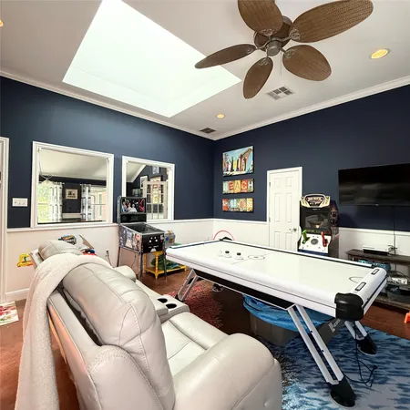 a kitchen with kitchen island a stove a refrigerator a sink dishwasher with a dining table and chairs with wooden floor