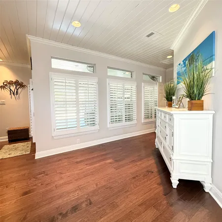 an aerial view of a house with swimming pool and large trees