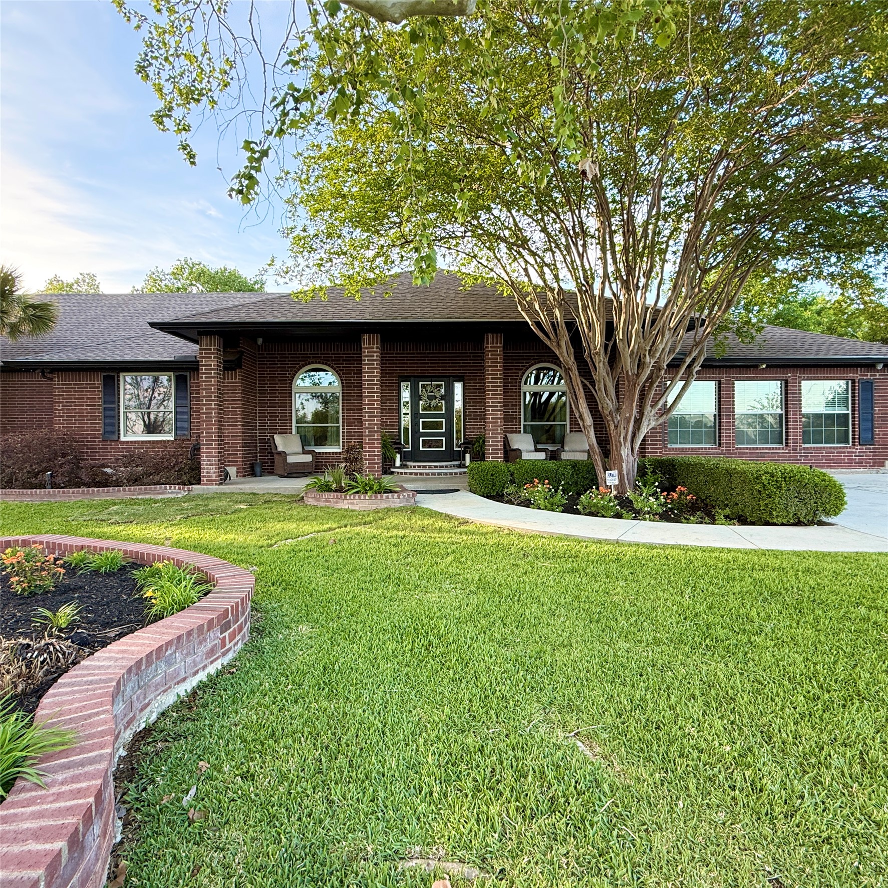 1902 Rowe Loop Pflugerville, TX 78660 - Photo 3 of 38 Ranch-style house featuring a front yard, brick siding, roof with shingles, and covered porch