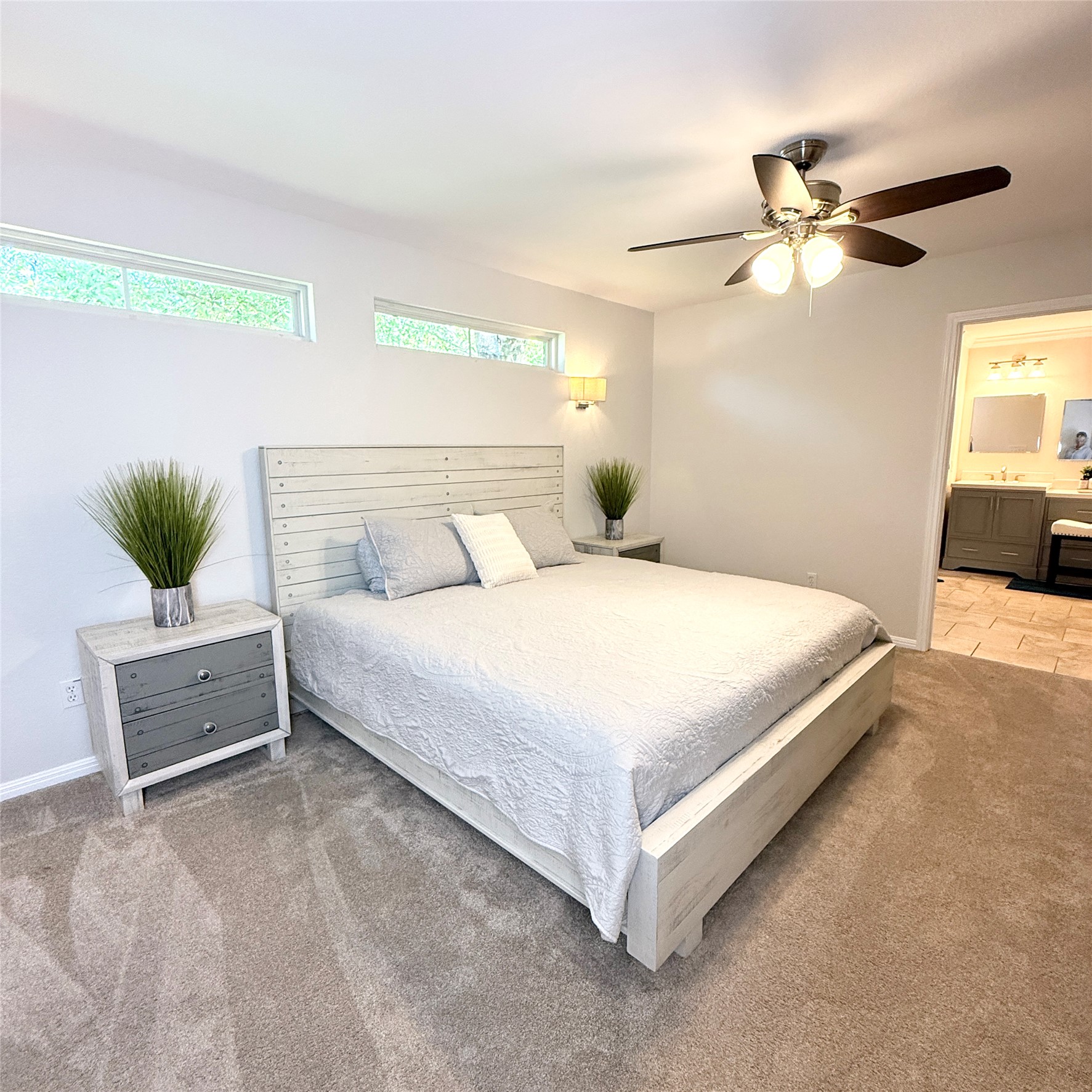 1902 Rowe Loop Pflugerville, TX 78660 - Photo 32 of 38 Guest House Bedroom with light colored carpet, a ceiling fan, and ensuite bath