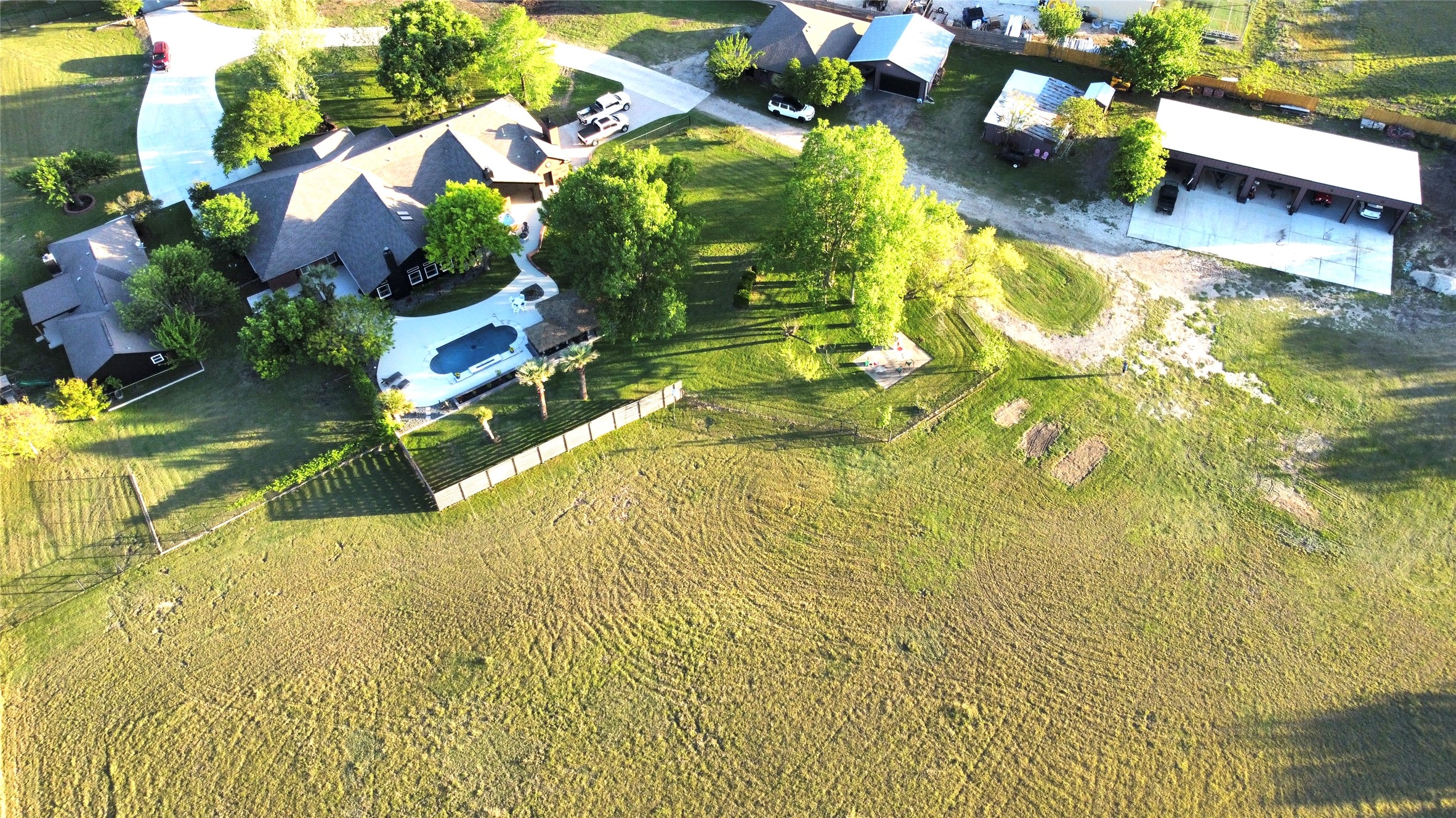1902 Rowe Loop Pflugerville, TX 78660 - Photo 6 of 38 Bird's eye view of main house, guest house, outbuildings, and more.