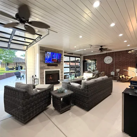 a room with furniture pool table and flat screen tv