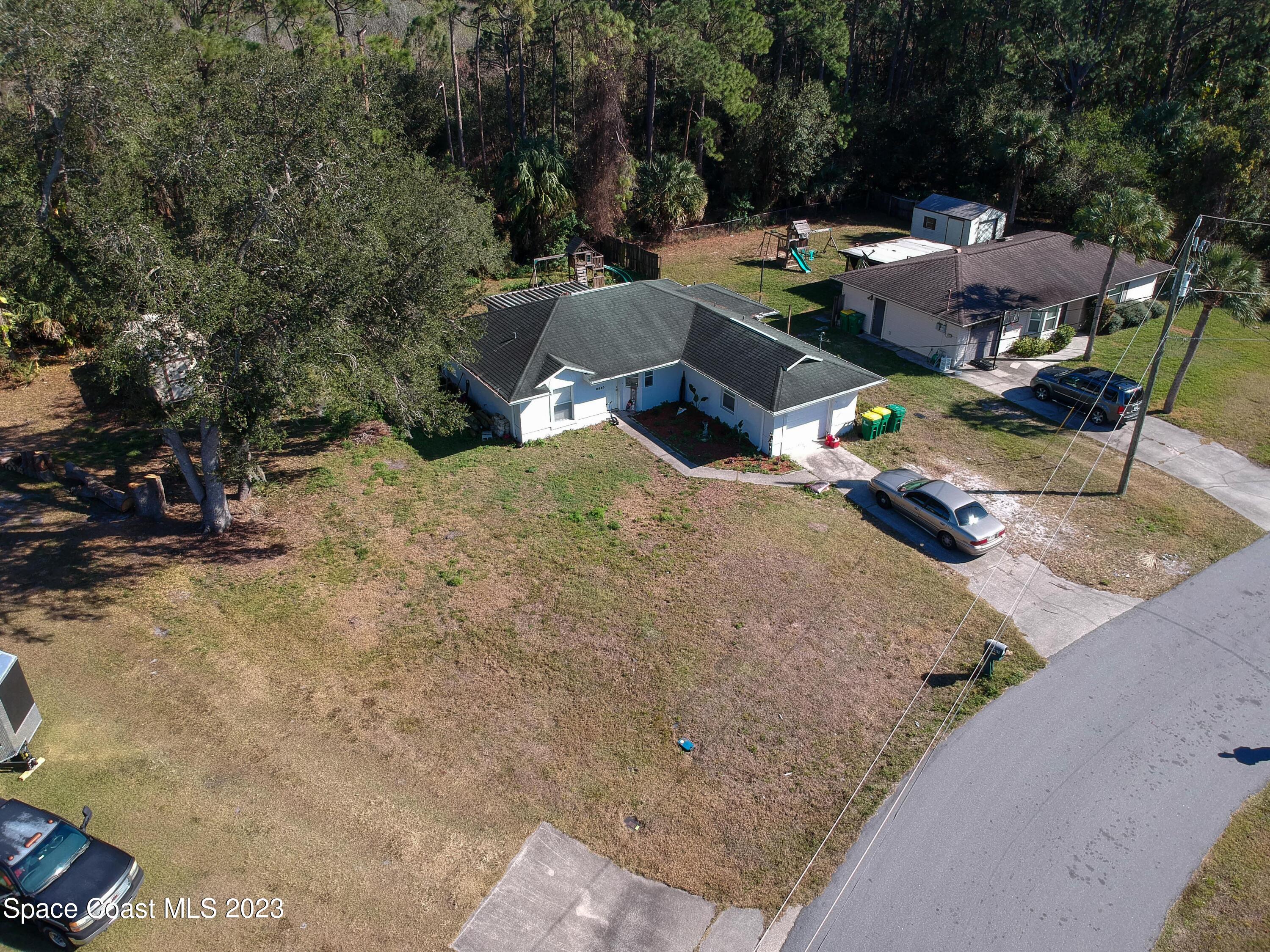 6845 Spring Street Cocoa, FL 32927 - Photo 3 of 45 an aerial view of a house with yard and seating space
