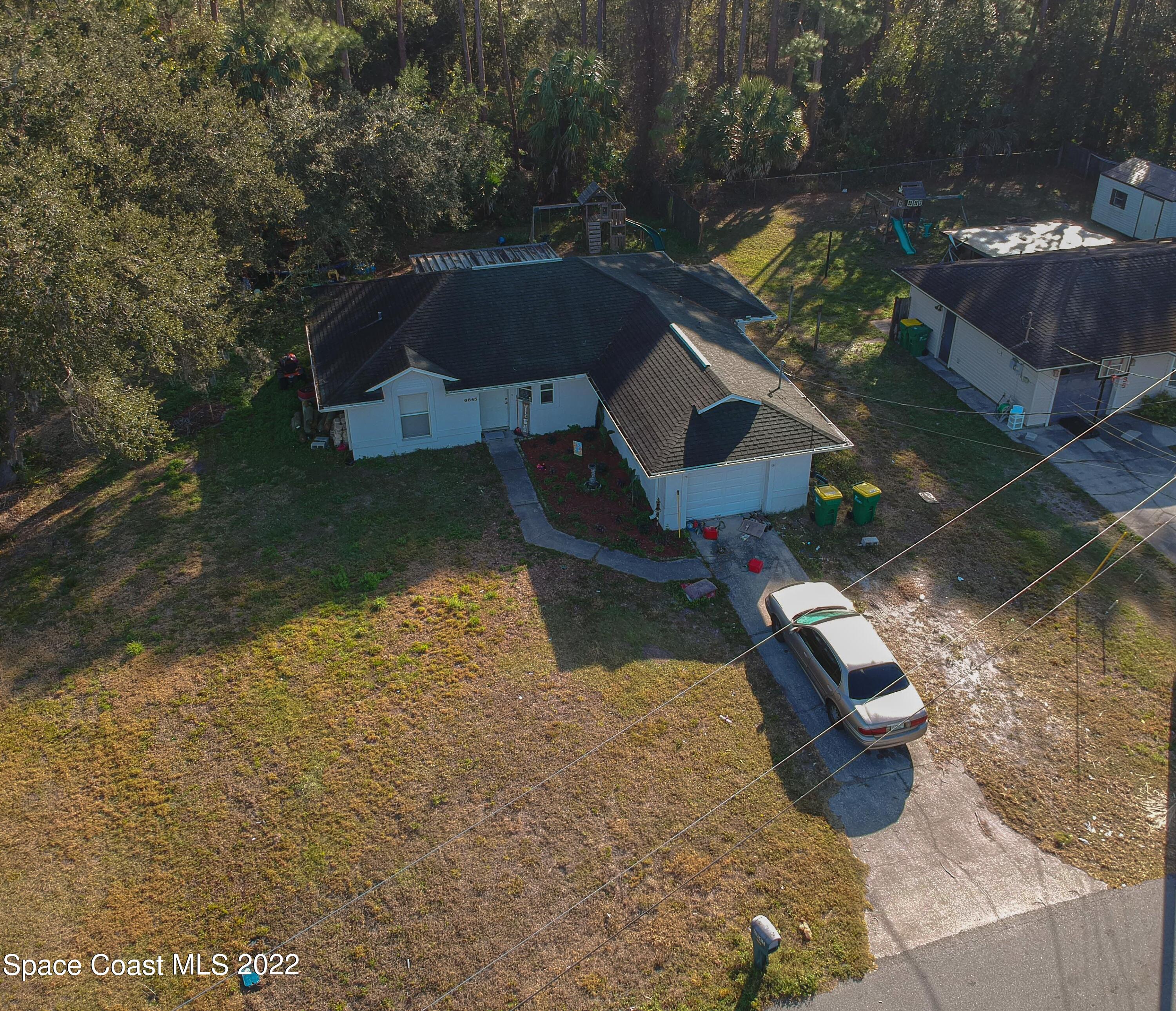 6845 Spring Street Cocoa, FL 32927 - Photo 5 of 45 an aerial view of a house with yard