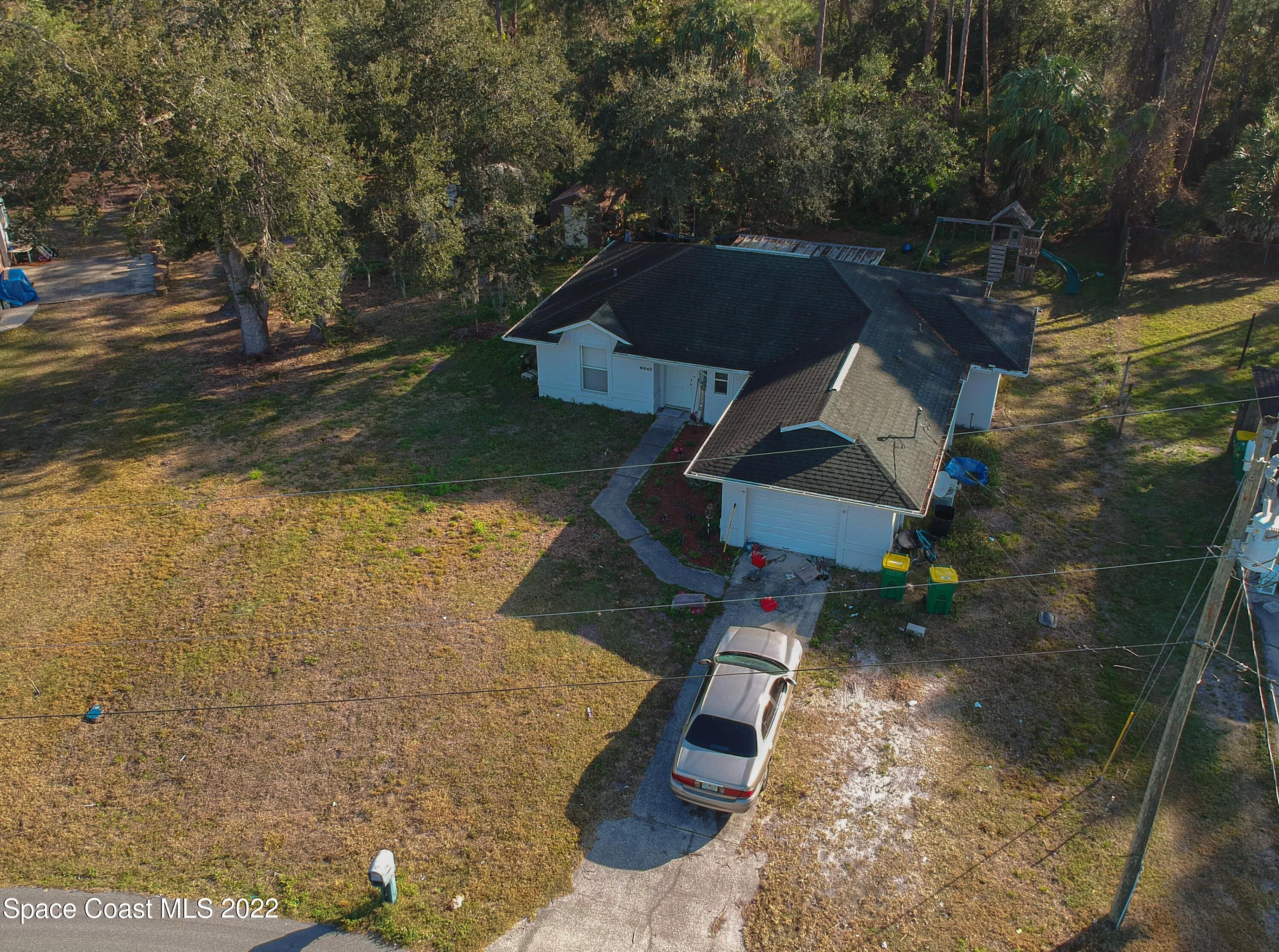 6845 Spring Street Cocoa, FL 32927 - Photo 6 of 45 an aerial view of residential houses with outdoor space