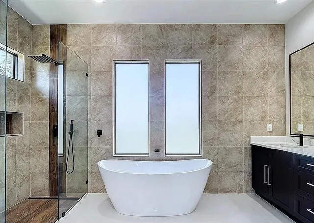 a bathroom with a bathtub and shower