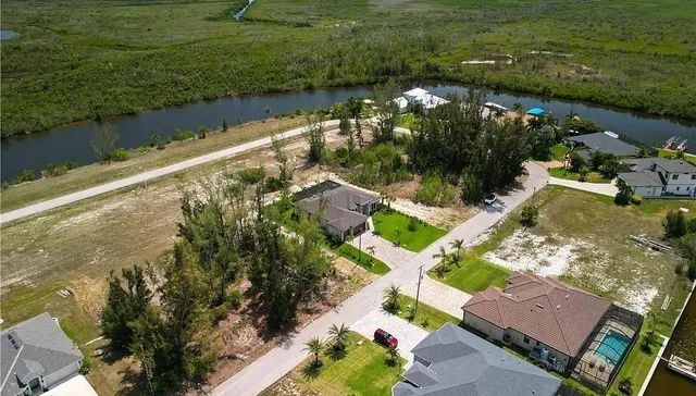 an aerial view of a house with yard and outdoor seating
