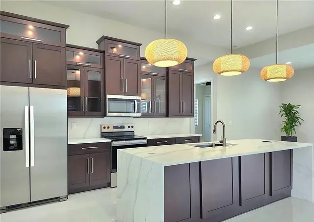 a kitchen with cabinets and stainless steel appliances