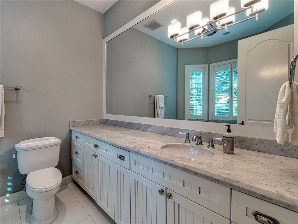 2920 Hunter Road Weston, FL 33331 - Photo 18 of 51 a bathroom with a granite countertop sink a toilet and a mirror