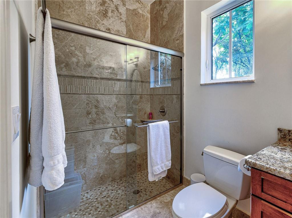 2920 Hunter Road Weston, FL 33331 - Photo 22 of 51 a white toilet sitting next to a bathroom sink and a shower