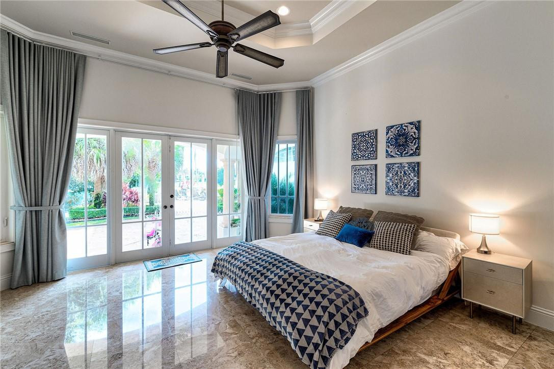 2920 Hunter Road Weston, FL 33331 - Photo 34 of 51 a bedroom with a large bed and a large window
