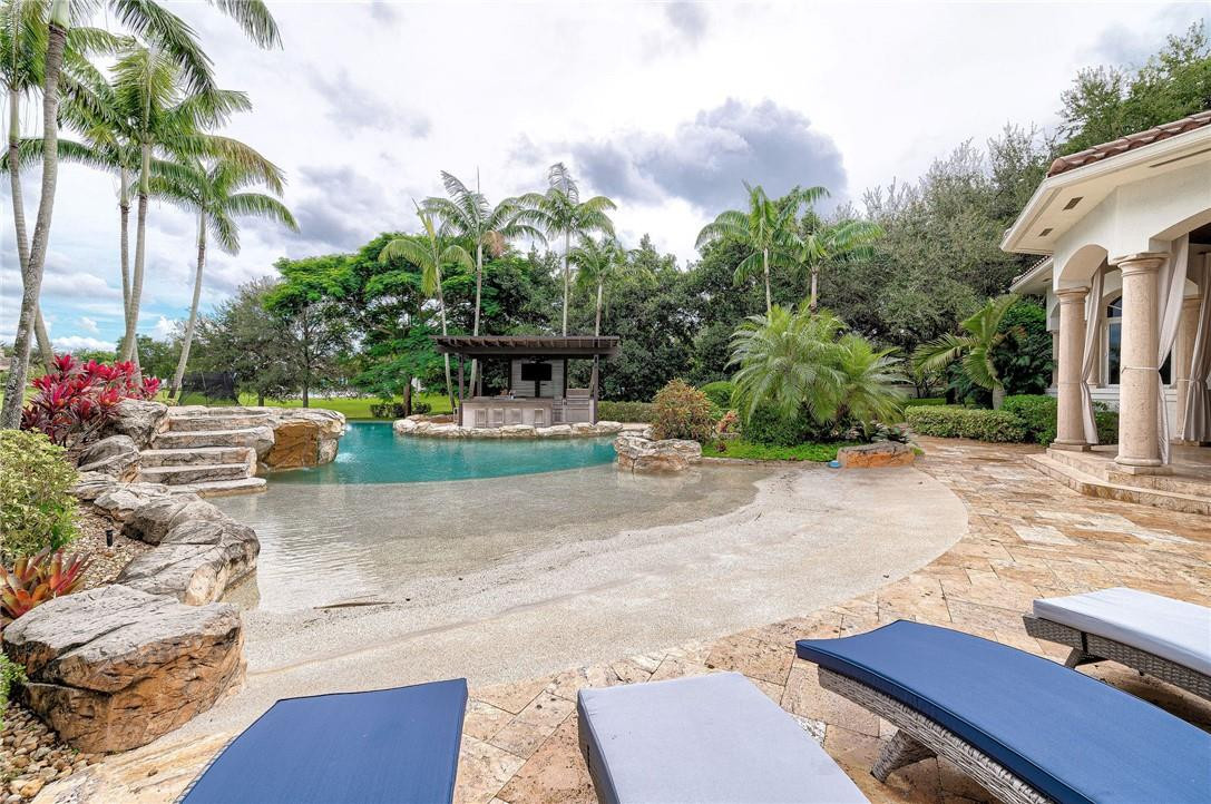 2920 Hunter Road Weston, FL 33331 - Photo 47 of 51 a view of a backyard with plants and palm trees