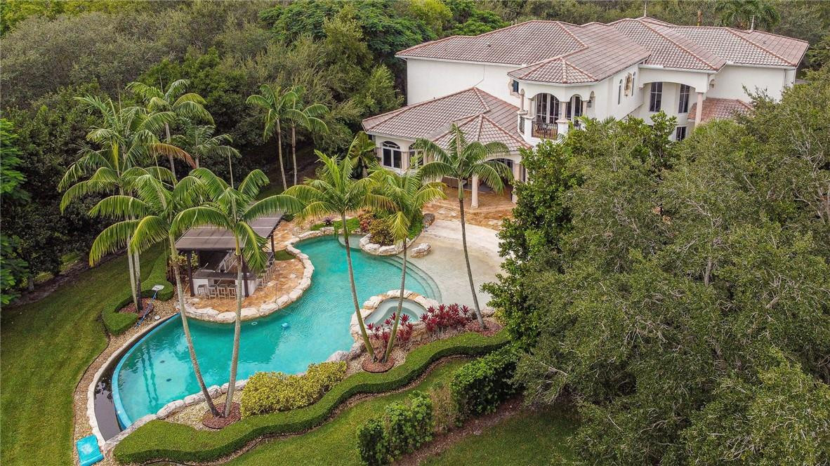 2920 Hunter Road Weston, FL 33331 - Photo 50 of 51 an aerial view of a house with a garden and lake view