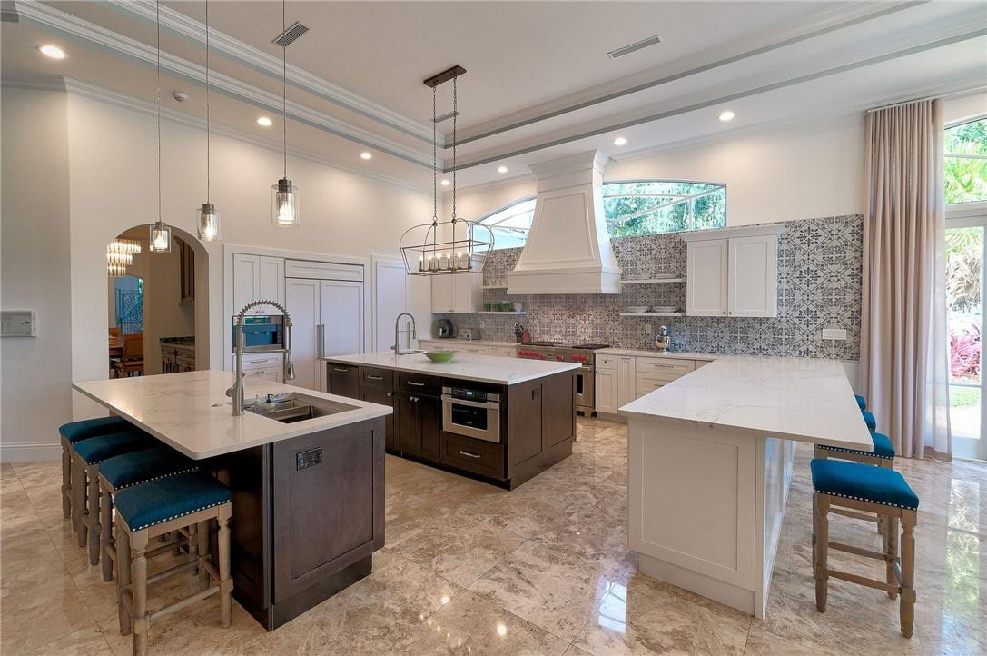 2920 Hunter Road Weston, FL 33331 - Photo 5 of 51 a large kitchen with a counter space a sink stainless steel appliances and cabinets