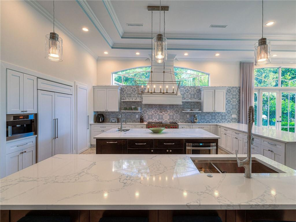2920 Hunter Road Weston, FL 33331 - Photo 6 of 51 a kitchen with kitchen island a large counter top a sink stainless steel appliances and cabinets