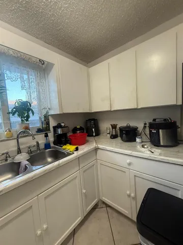 a kitchen with stainless steel appliances granite countertop a sink a stove and cabinets