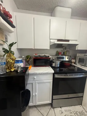 a kitchen with a stove and a refrigerator