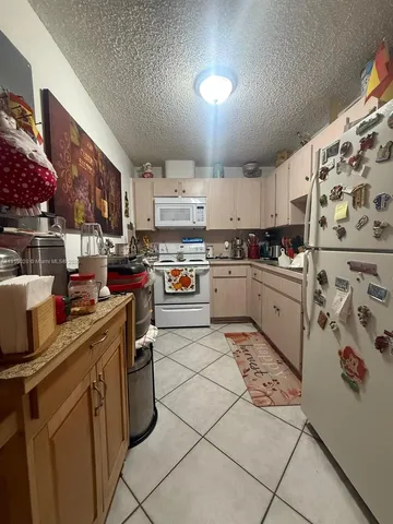 a kitchen with a sink window and stainless steel appliances
