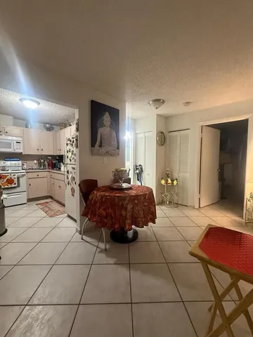 a spacious bedroom with a bed a couch and a television in it