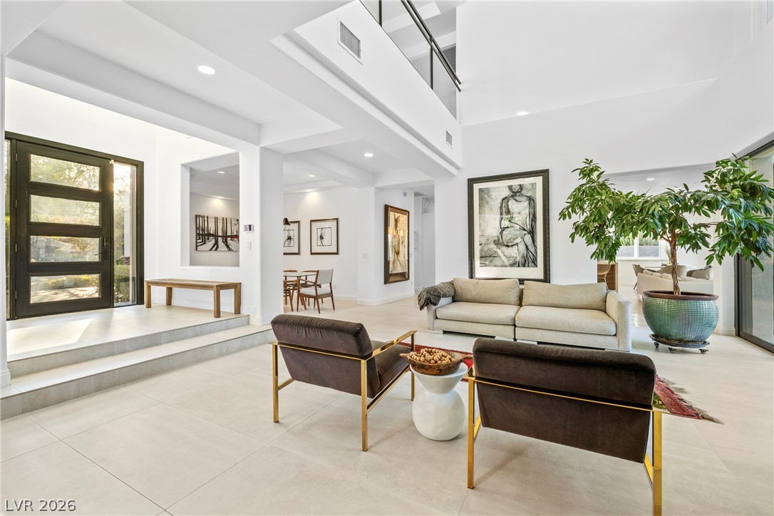 2000 Grouse Street Las Vegas, NV 89134 - Photo 4 of 89 A grand entrance welcomes guests into a bright, airy living space with soaring ceilings and modern aesthetics.