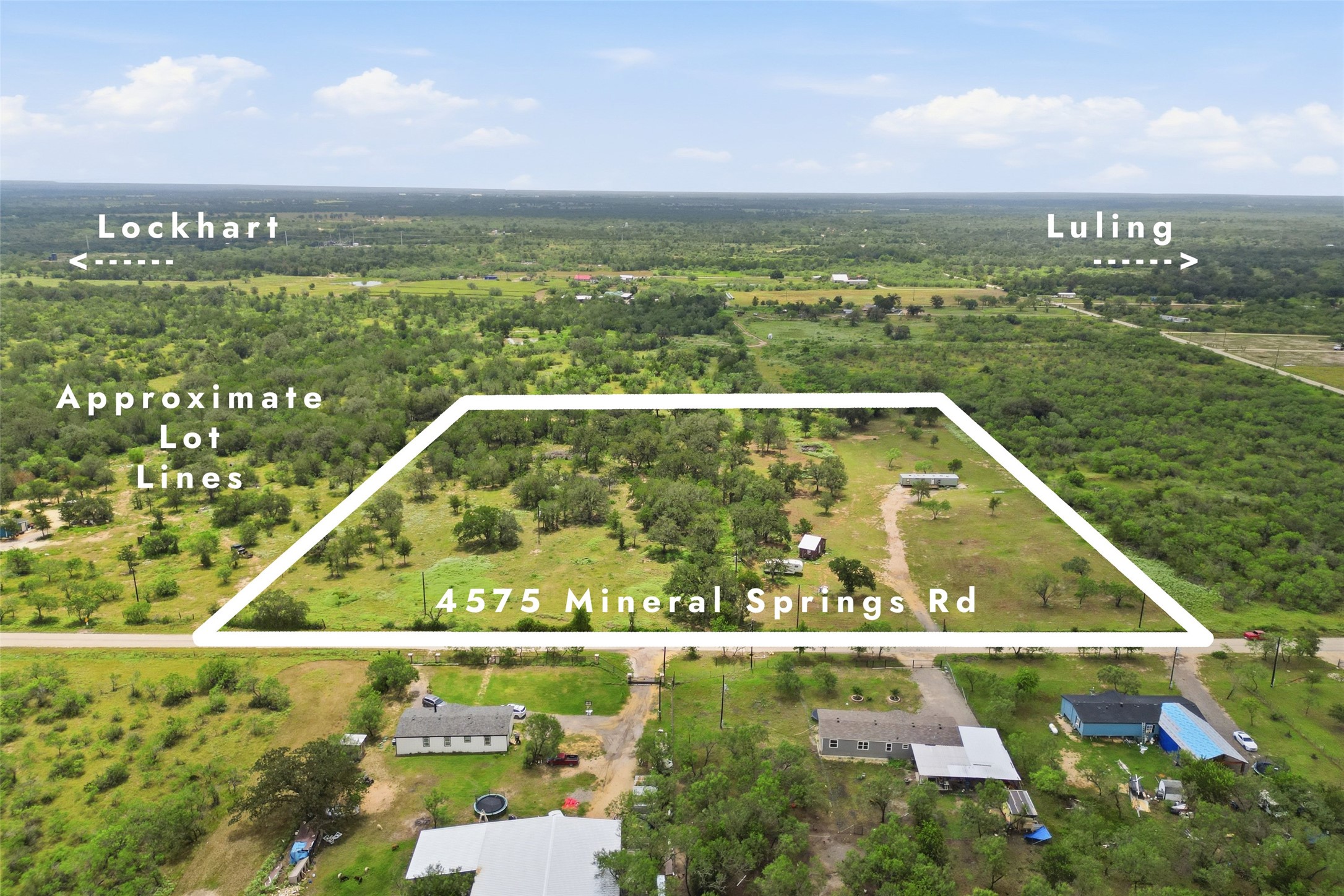 4575 Mineral Springs Road Lockhart, TX 78644 - Photo 1 of 1 An aerial view showcases a verdant rural landscape, highlighting approximate lot lines for potential development.