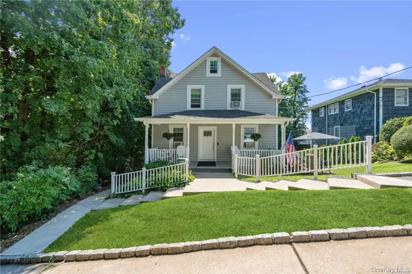 a front view of a house with a yard table and chairs