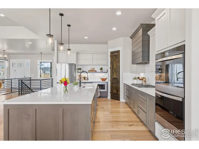 a kitchen with stainless steel appliances a sink and cabinets