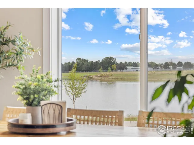 a living room with kitchen island furniture and a chandelier