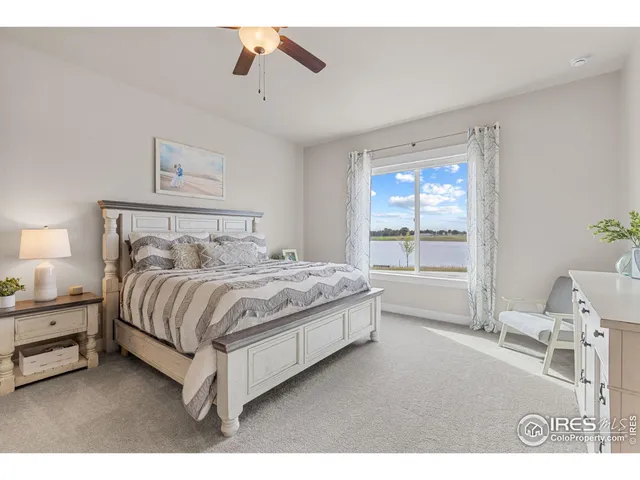 a bedroom with a bed and large window