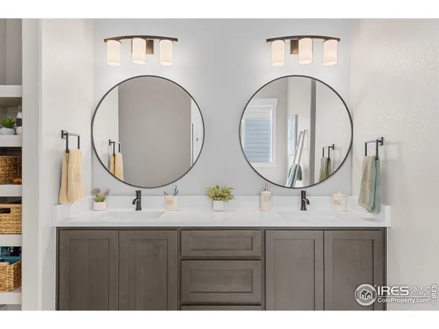 a bathroom with a double vanity sink and a mirror