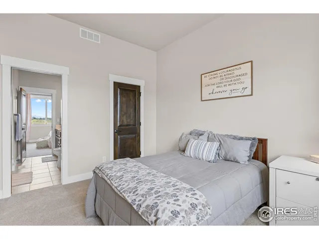a bedroom with furniture and a window