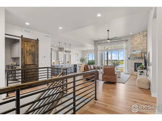 a living room with furniture a flat screen tv and a large window