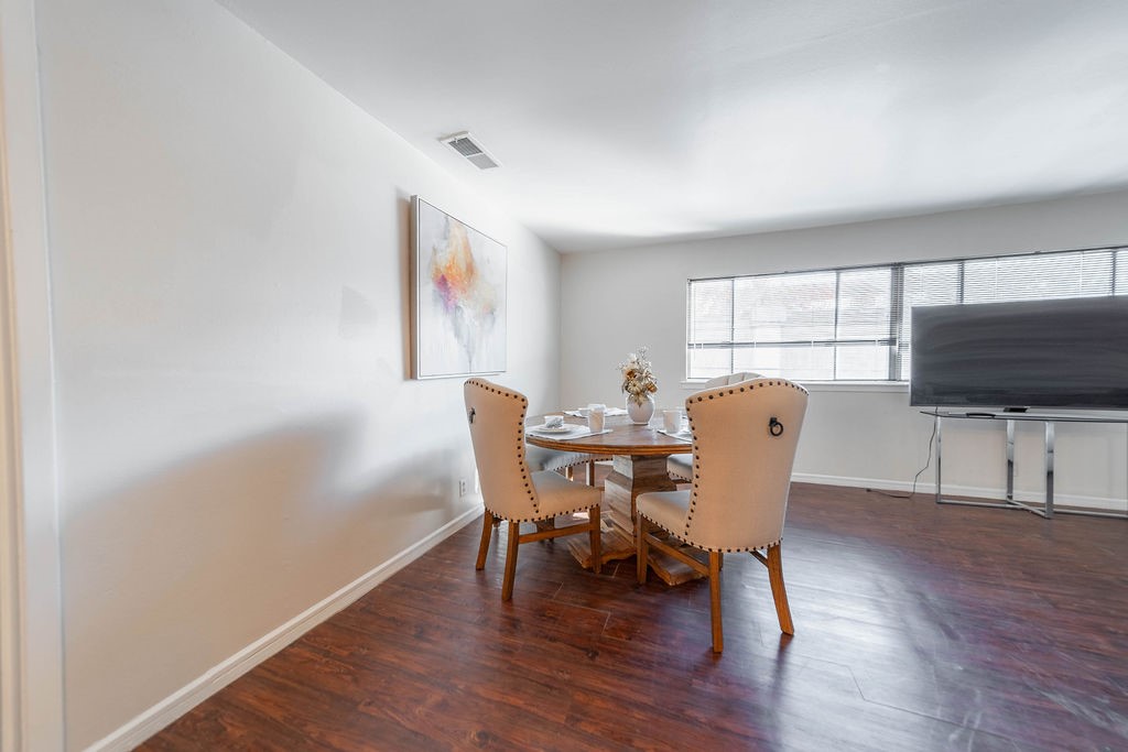 4723 Merwin Street Houston, TX 77027 - Photo 7 of 29 a view of a dining room with furniture window and wooden floor