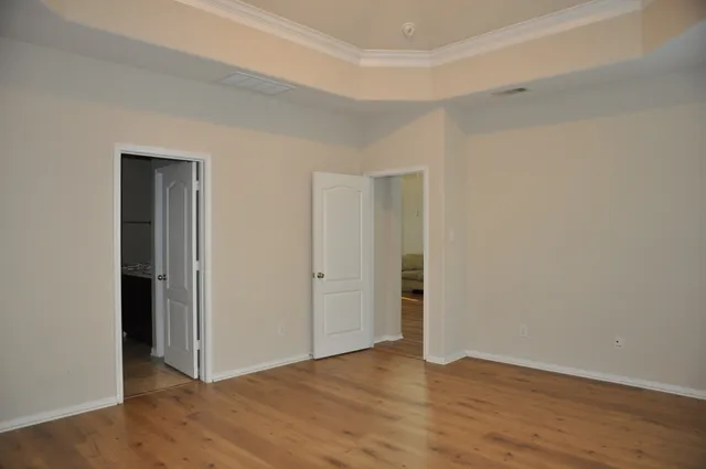 a view of an empty room and wooden floor
