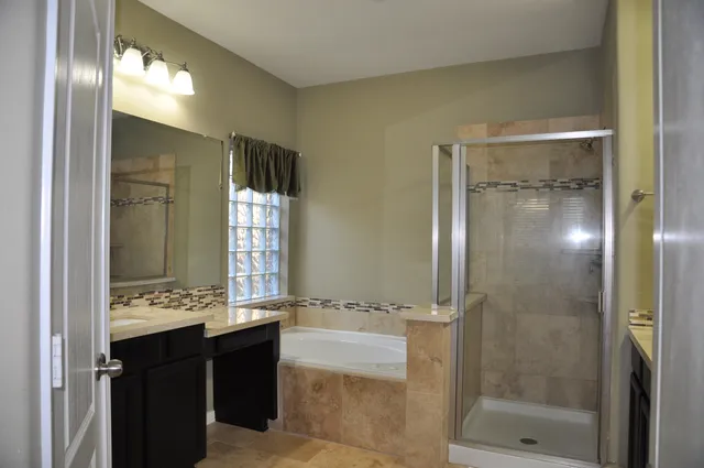 a bathroom with a double vanity sink and a mirror