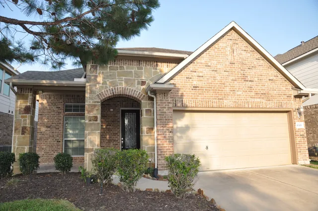 a view of a brick house with a large windows