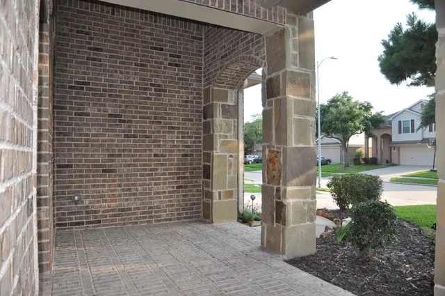 a view of a brick house with a potted plant