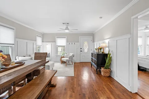 a living room with furniture a wooden floor and a fireplace