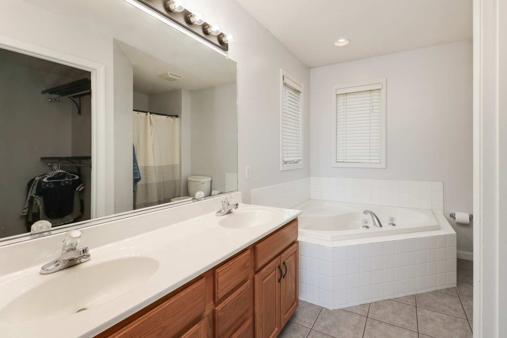1505 Torrey Pines Road Normal, IL 61761 - Photo 21 of 38 a bathroom with a tub sink and mirror
