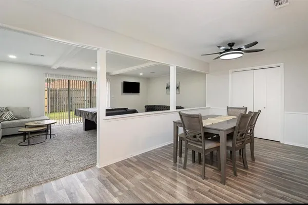 a dining room with furniture and wooden floor