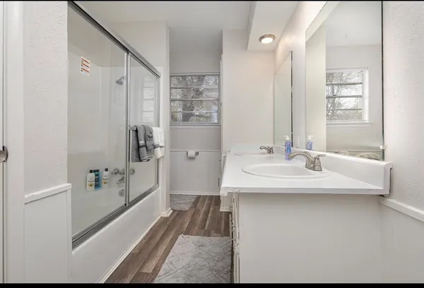 a bathroom with a sink a shower and a mirror