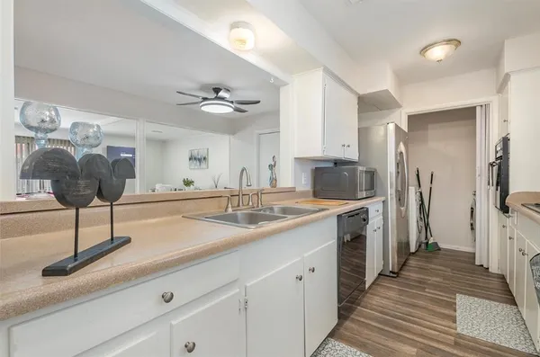 a kitchen with a sink and refrigerator