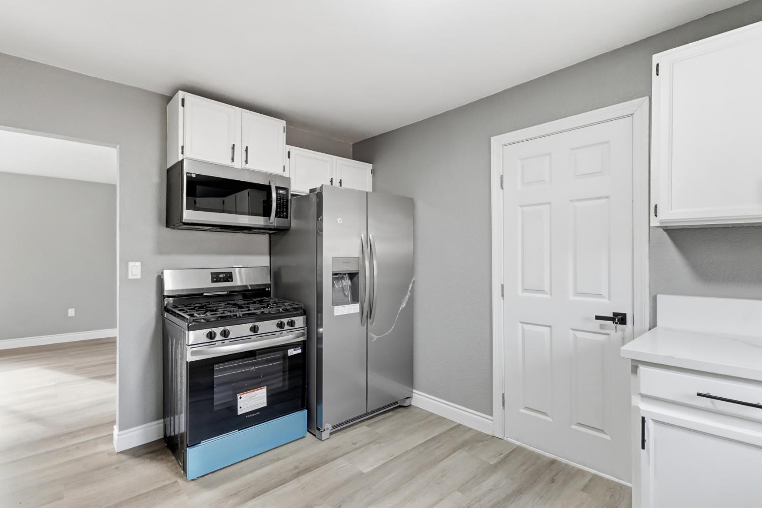 1099 Grand Avenue Olivehurst, CA 95961 - Photo 11 of 38 a kitchen with stainless steel appliances a stove a microwave and a refrigerator