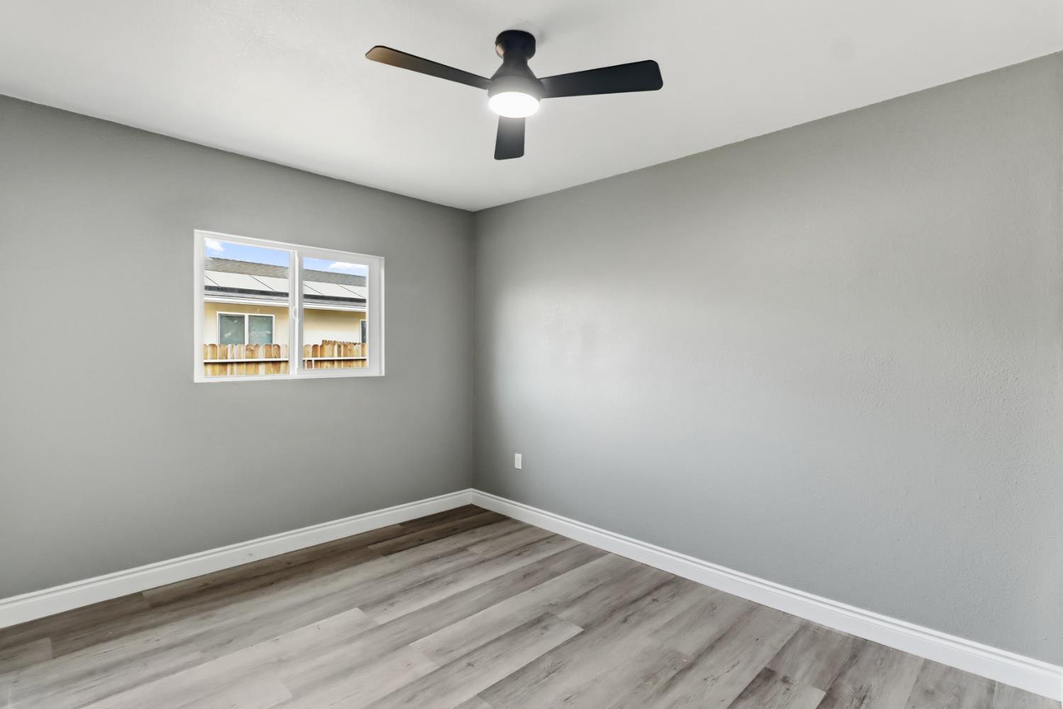 1099 Grand Avenue Olivehurst, CA 95961 - Photo 14 of 38 an empty room with a window and a ceiling fan
