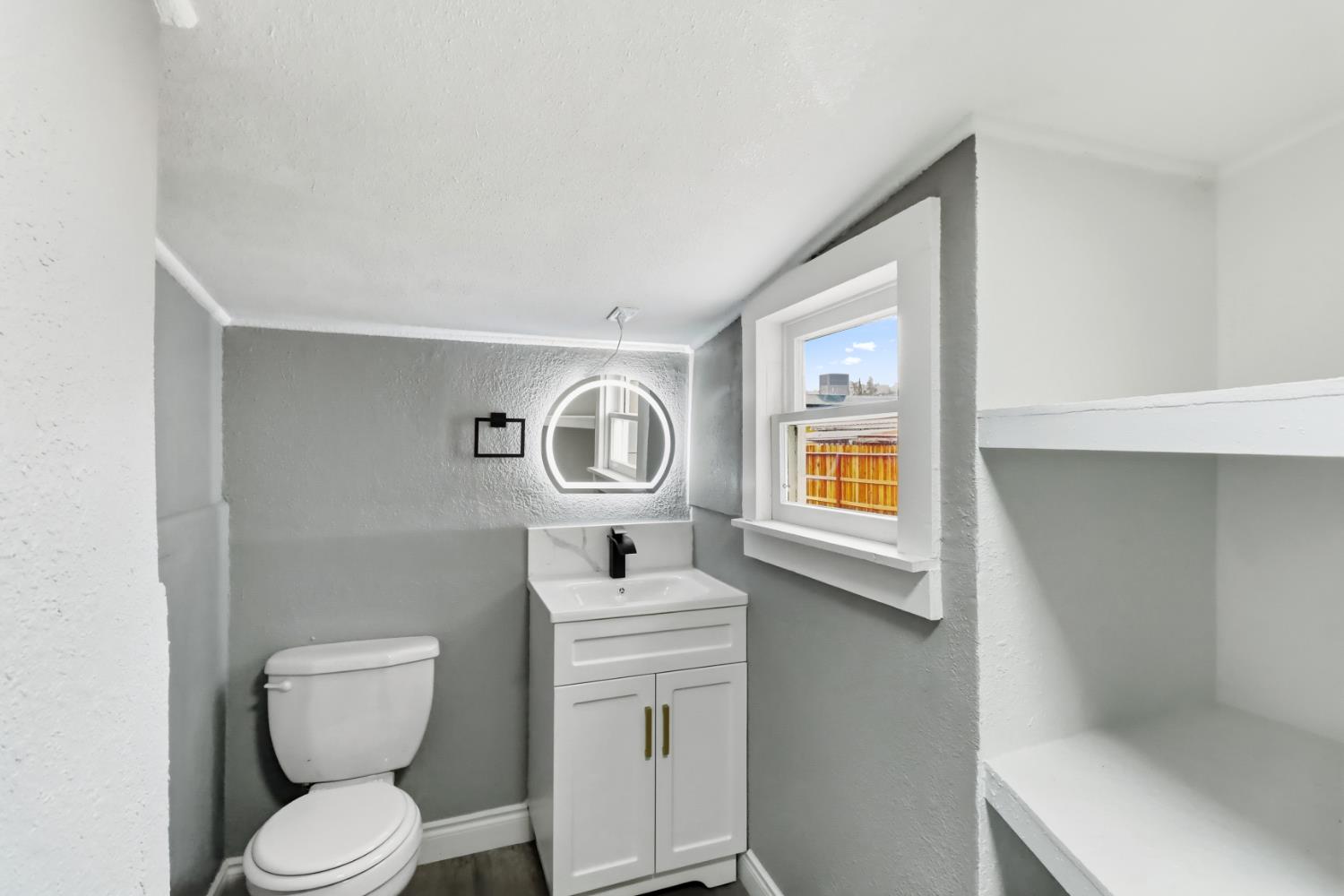 1099 Grand Avenue Olivehurst, CA 95961 - Photo 19 of 38 a white toilet sitting next to a bathroom sink