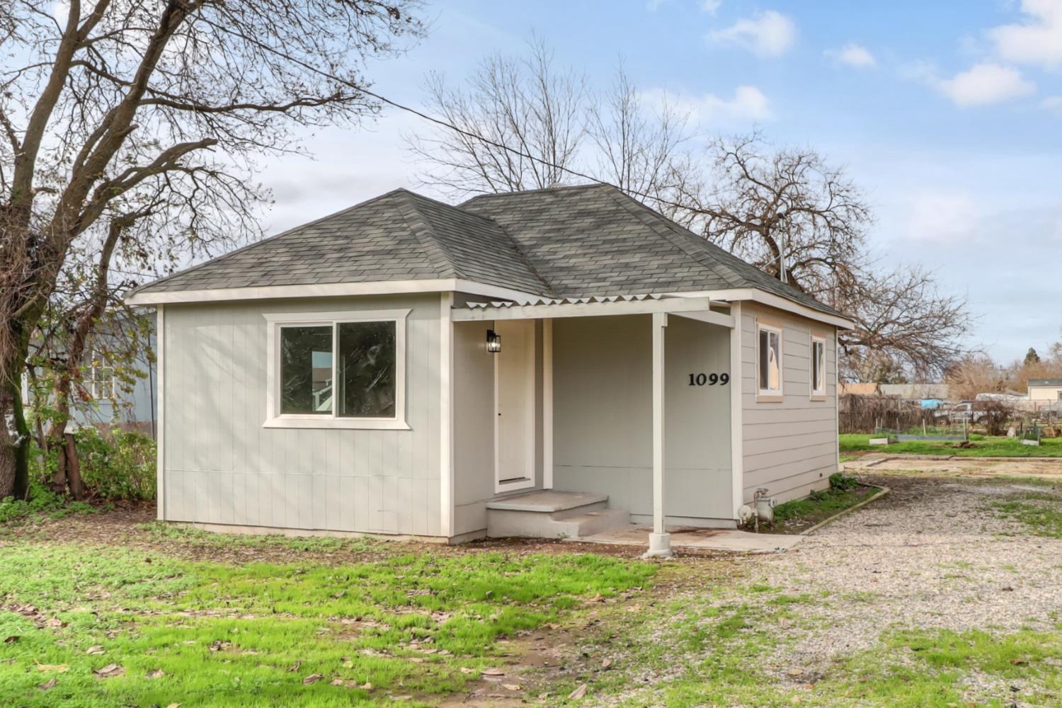 1099 Grand Avenue Olivehurst, CA 95961 - Photo 2 of 38 a house that has a tree in front of the house