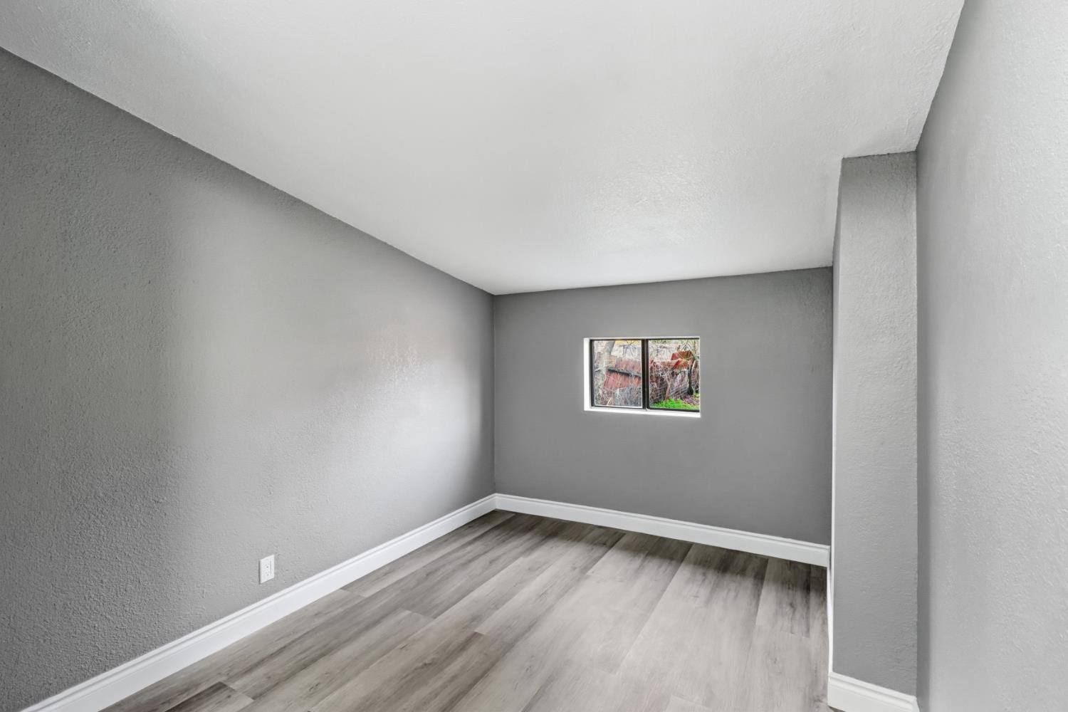 1099 Grand Avenue Olivehurst, CA 95961 - Photo 22 of 38 a view of empty room with wooden floor and fan